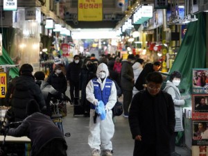 Nhân viên y tế khử trùng một khu chợ ở thủ đô Seoul, Hàn Quốc ngày 24-2. Ảnh: AFP
